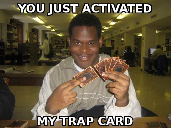 A photo of a man holding Yu-Gi-Oh trading cards with a sinister look on his face. Over laid is white text that reads "You have activated my trap card".